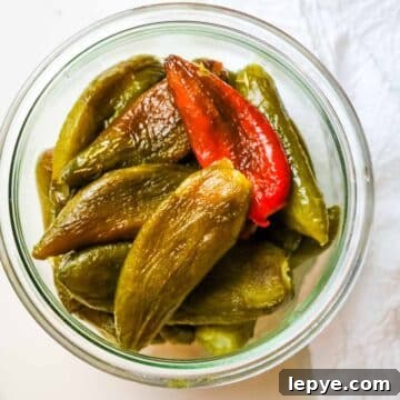 roasted and peeled peppers in a jar.