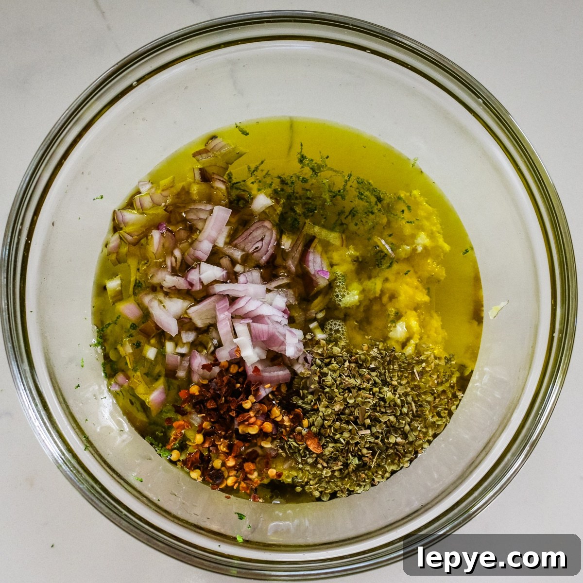 Cilantro Chimichurri Sauce Recipe — Fresh Herb Marinade for Grilled Meats 6 cilantro chimichurri sauce mixture in glass bowl.