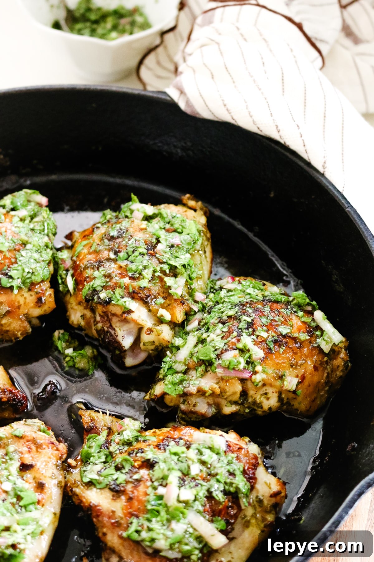 Cilantro Chimichurri Sauce Recipe — Fresh Herb Marinade for Grilled Meats 8 chimichurri chicken thighs in cast iron skillet.