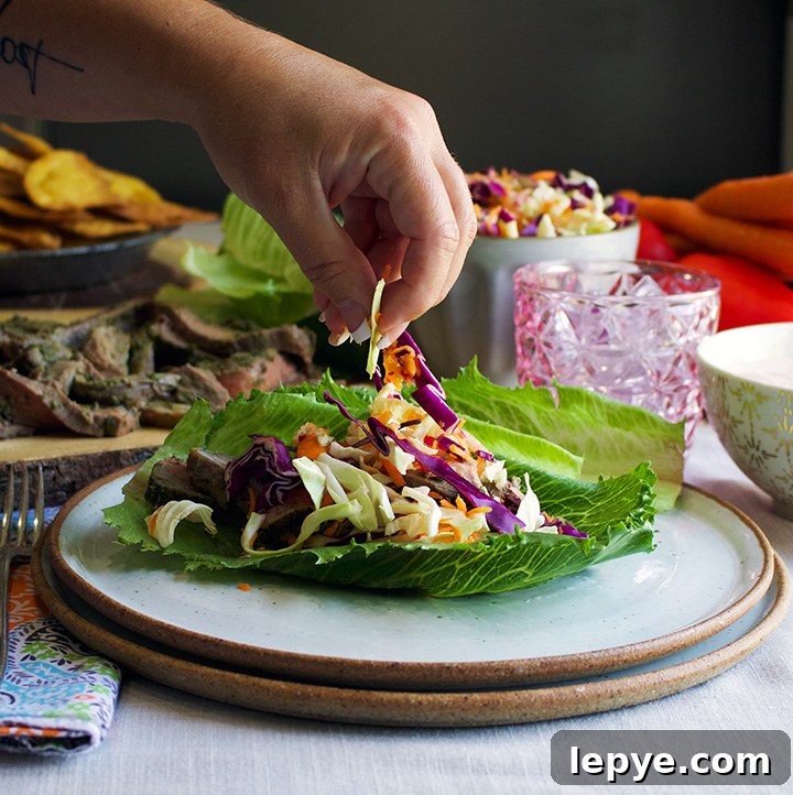 Steak Salad Wraps with Tangy Chimichurri and Crisp Veggies 4 Sprinkling vegetables over steak for Steak salad wraps with chili yogurt sauce and crushed tortilla chips.