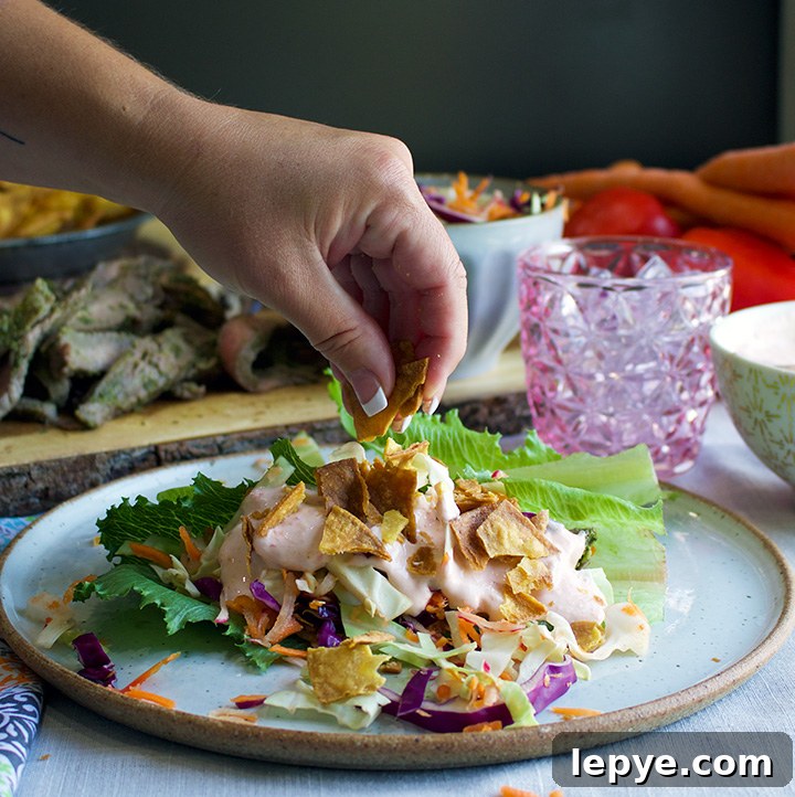 Steak Salad Wraps with Tangy Chimichurri and Crisp Veggies 6 Sprinkling tortilla chips over steak salad wraps.