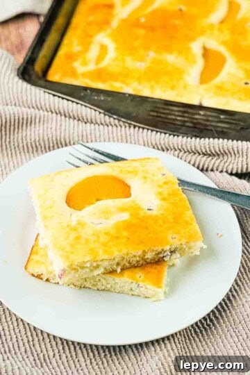 Sheet pan pancakes cut into squares and placed on a white plate.