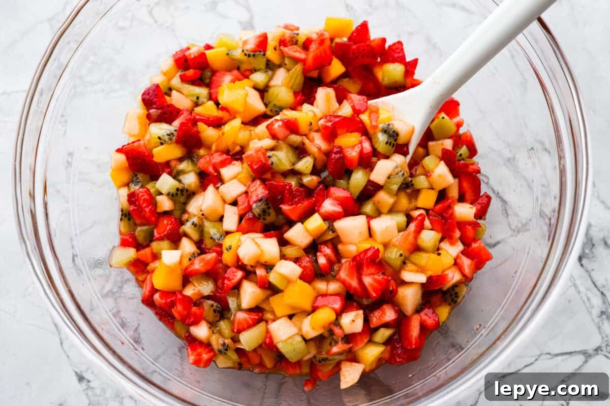 Vibrant fruit salsa is a fresh, juicy twist on your favorite snack! Sweet berries, tropical mango, and a splash of lime always steal the spotlight! Especially when served with crispy cinnamon chips! Raspberry jam mixed in with the diced fruit.