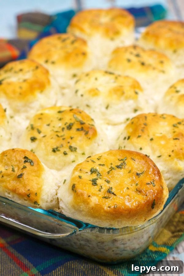 a 9x13 inch glass dish featuring a biscuits and gravy casserole.