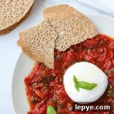 Smoky Grilled Tomatoes with Burrata and Crispy Crispbread 6 A plate with tomatoes, basil, burrata and crispbread