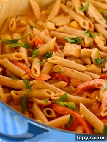 Chicken fajita pasta in a large blue pot.