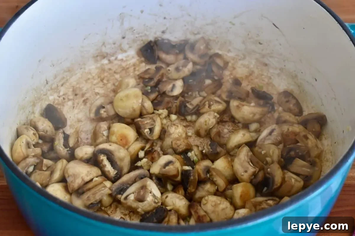 Stovetop Pan-Roasted Vegetables with Garlic White Beans 5 Cooked mushrooms in a large pot.