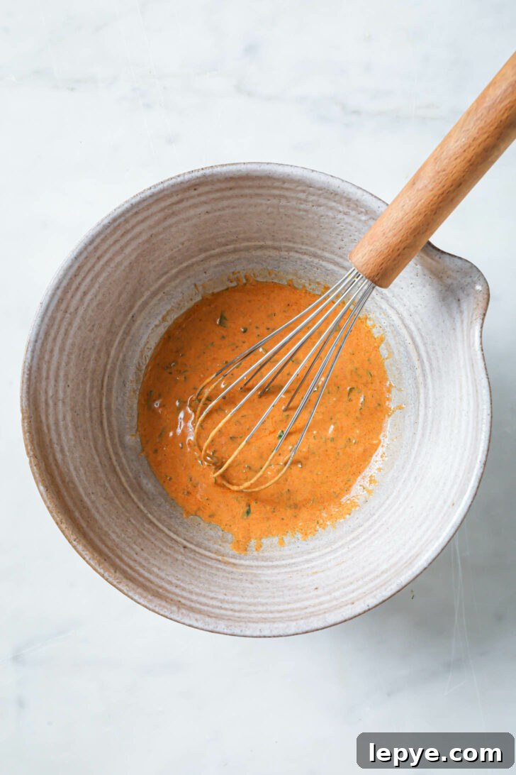 25-Minute Salmon Tikka Recipe: Quick Spiced Fish Tikka 6 Tandoori marinade in a bowl with a whisk.
