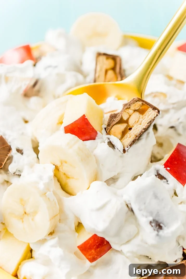 This Snickers Salad is an easy and addictive 4-ingredient no-bake dessert salad made with Snickers, banana, apples, and Cool Whip!