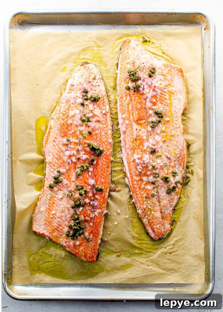 Slow-Roasted Salmon with Shallots, Capers & Lemon Pan Sauce 2 two slow roasted salmon fillets on a sheet pan