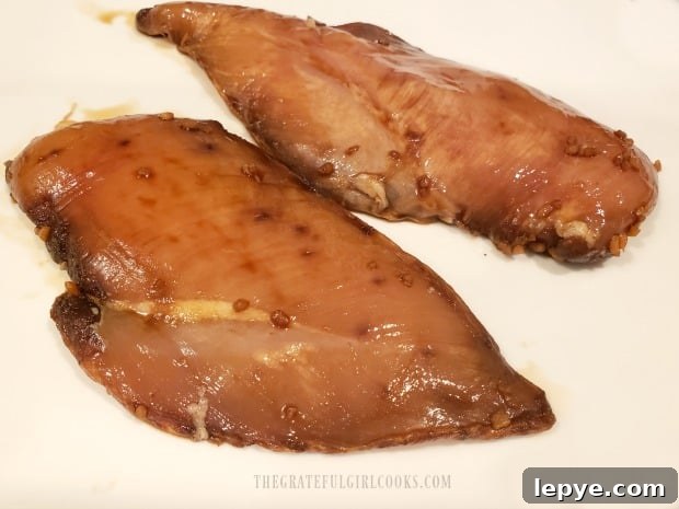 Two chicken breasts after being marinated for 30 minutes.