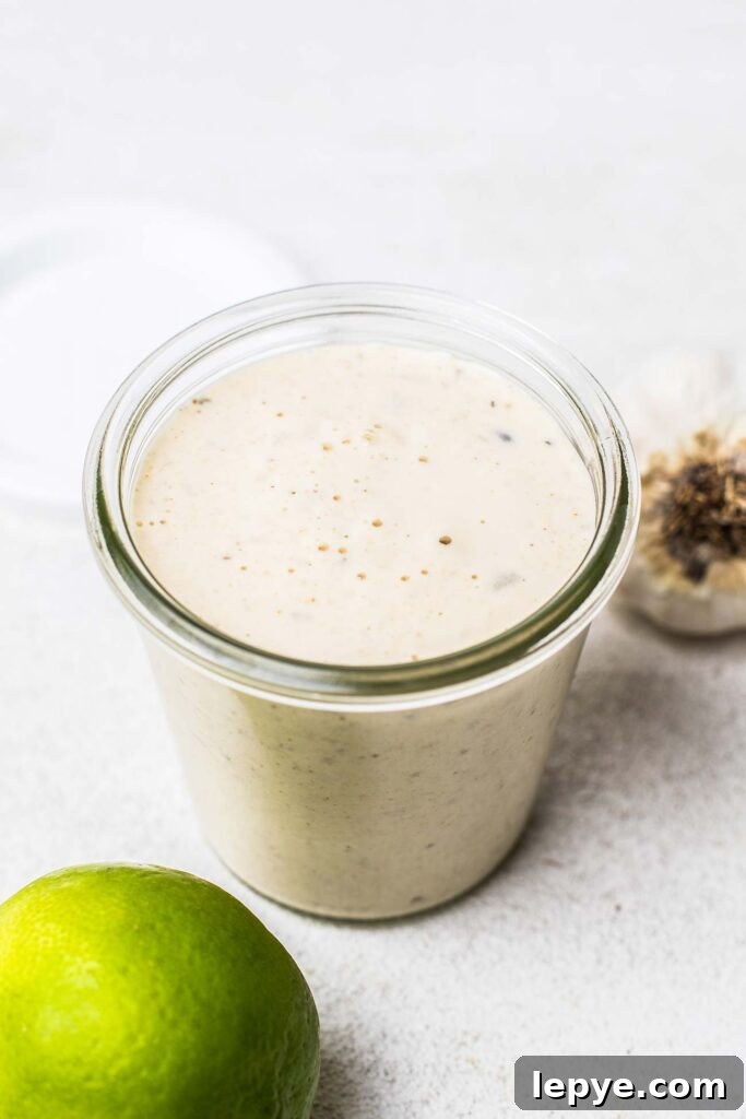 A creamy dressing in a clear glass jar.