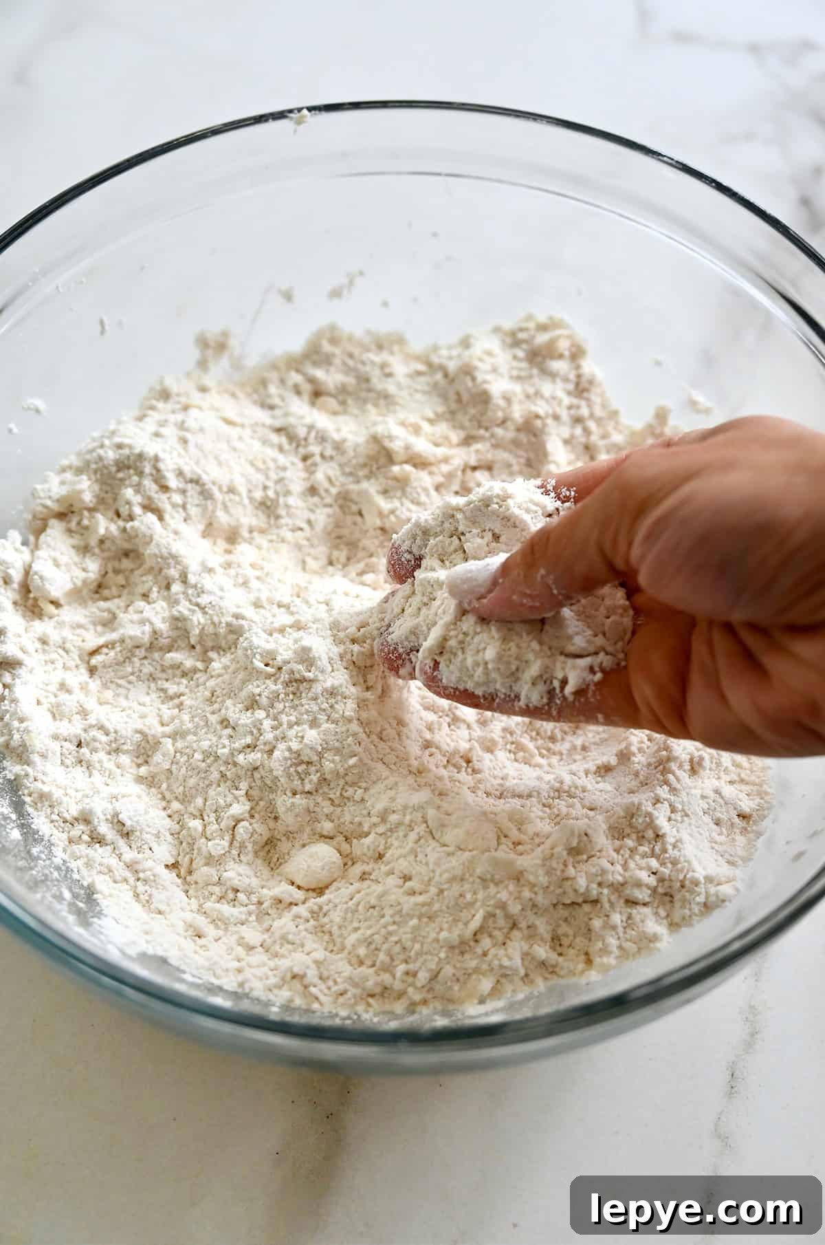 Cutting cold, cubed butter into flour.