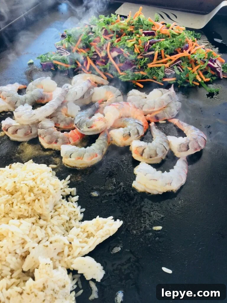 rice shrimp and veggies cooking on the griddle