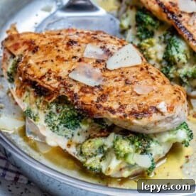Broccoli-Stuffed Chicken Breast Recipe for Juicy Oven-Baked Meals 9 Stuffed chicken breast with broccoli and cheese on a stainless steel pan.