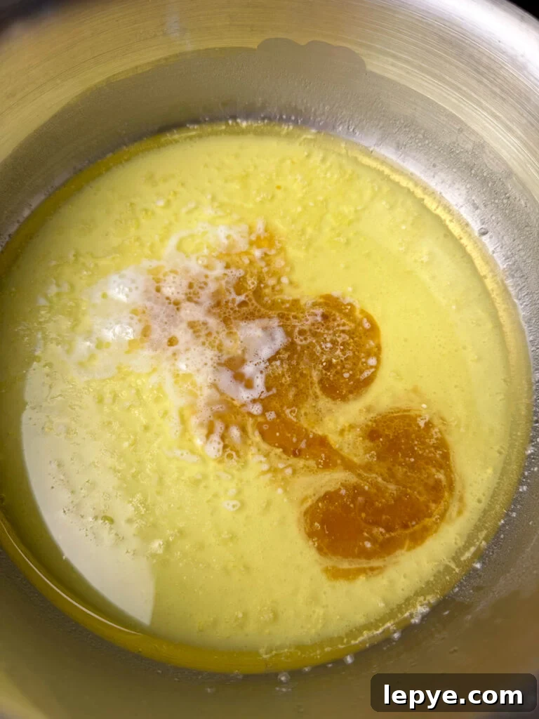 Southern-Style White Texas Sheet Cake Recipe 7 Vanilla added to melted butter in a saucepan.