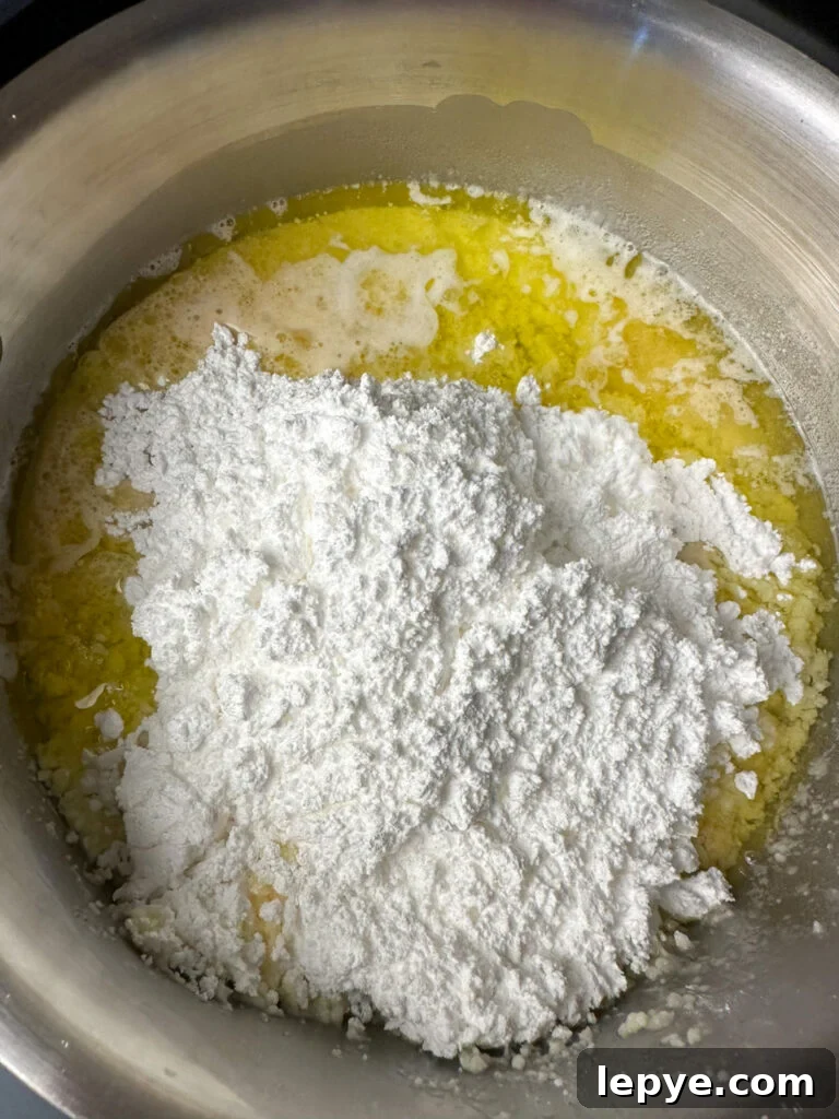 Southern-Style White Texas Sheet Cake Recipe 8 Powdered sugar added to melted butter and sugar.