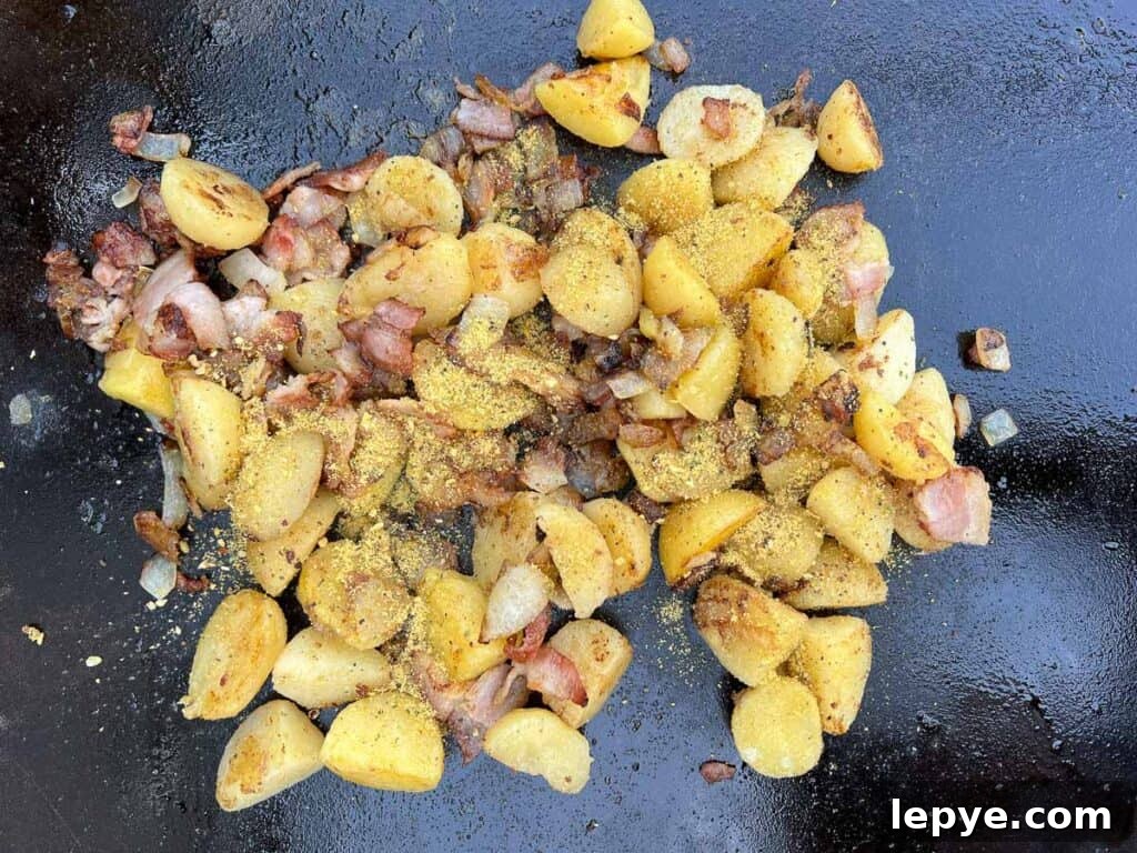 Crispy Blackstone Fried Potatoes: Simple Skillet Recipe 6 fry the potatoes, season, and combine with onions and bacon