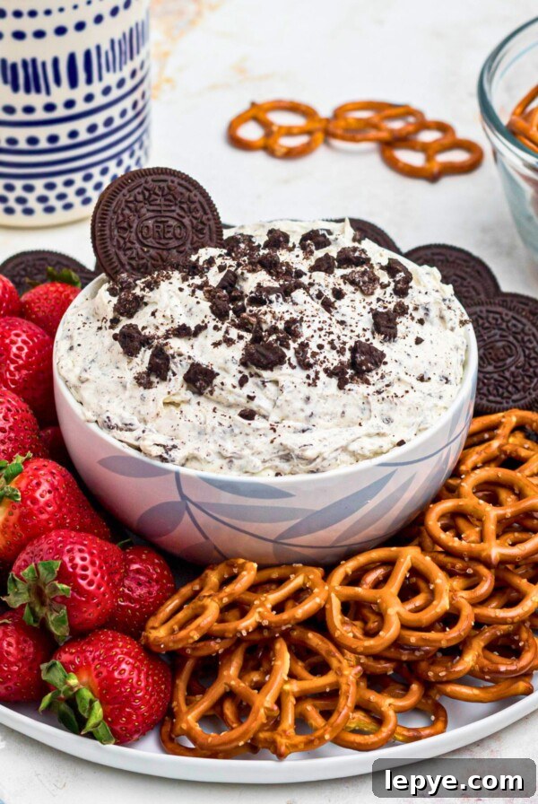 Crispy Oven-Roasted Potatoes with Garlic and Herbs 11 Strawberries, pretzels, and chocolate cookies, on a round white plate, around a cookies and cream Oreo dip, on a marble table.