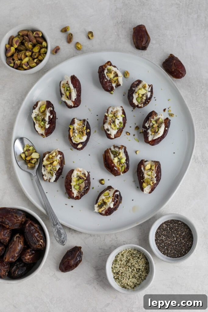 Savory Stuffed Dates: Flavorful Appetizer Recipes for Entertaining 2 Dates stuffed with cream cheese and topped with pistachios, hemp hearts, and chia seeds on white plate