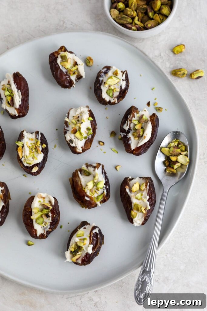 Savory Stuffed Dates: Flavorful Appetizer Recipes for Entertaining 7 Dates stuffed with cream cheese and topped with pistachios on white plate