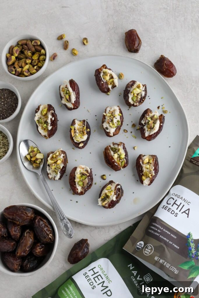 Savory Stuffed Dates: Flavorful Appetizer Recipes for Entertaining 9 Dates stuffed with cream cheese and topped with pistachios, hemp hearts, and chia seeds on white plate