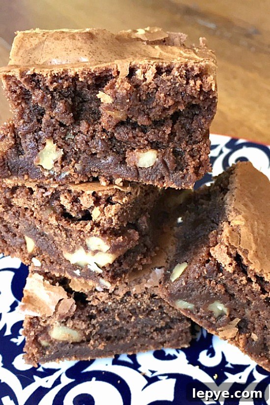 Chewy Walnut Brownies with Gooey Chocolate Center 4 brownies on plate