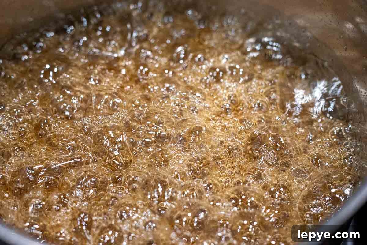 How to Make Homemade Marshmallows from Scratch 5 Sugar, maple syrup and water boiling in a saucepan.