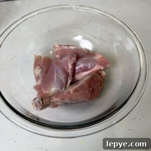 Authentic Jamaican Brown Stew Chicken Recipe 4 Skinless chicken in a bowl.