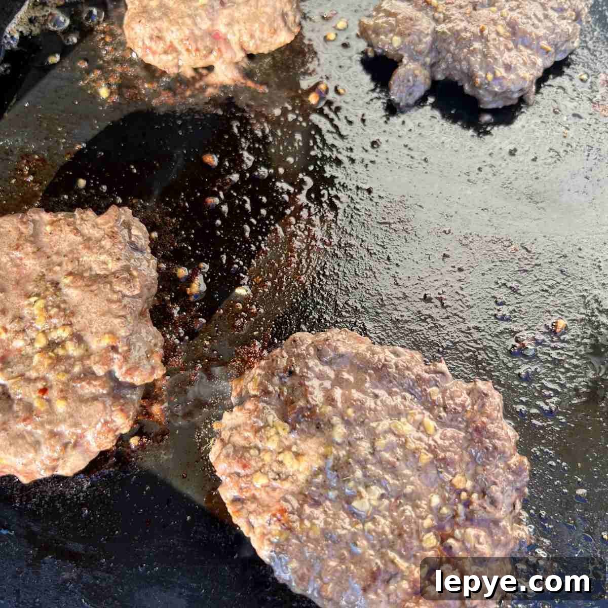 Blackstone Burger Cooking Guide: Tips for Juicy, Crispy Patties 5 Cooked burgers on Blackstone griddle.