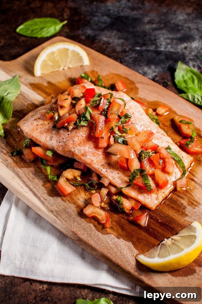 Pomodoro Salmon Bruschetta: Tomato & Herb Topping on Crispy Bread 2 a piece of bruschetta salmon on a wooden board with lemon wedges