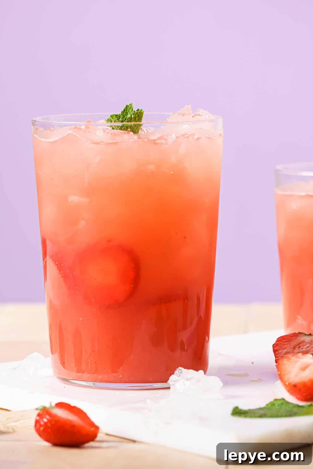 An image of strawberry acai refresher in a glass with ice.
