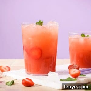 An image of strawberry acai refresher in a glass with ice.