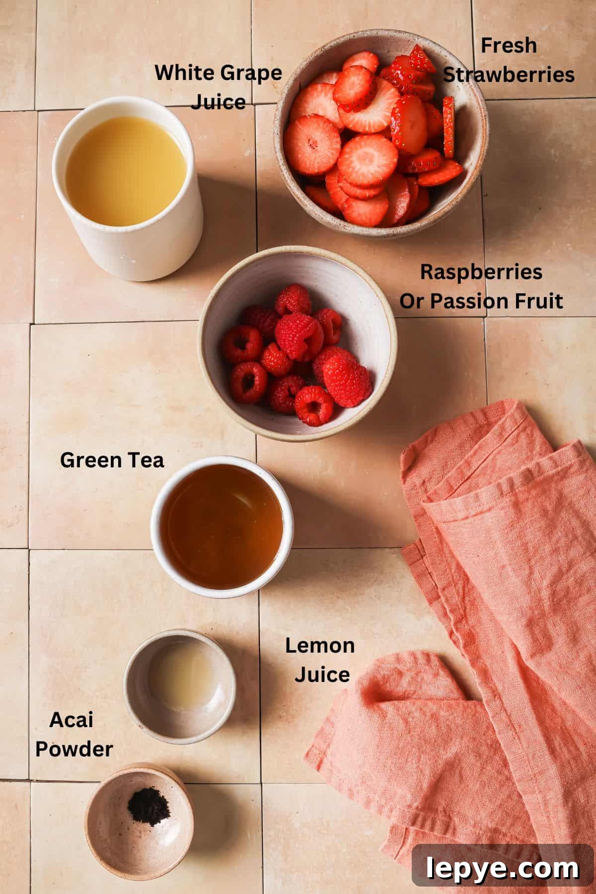 An overhead image the ingredients of strawberry acai refreshser.