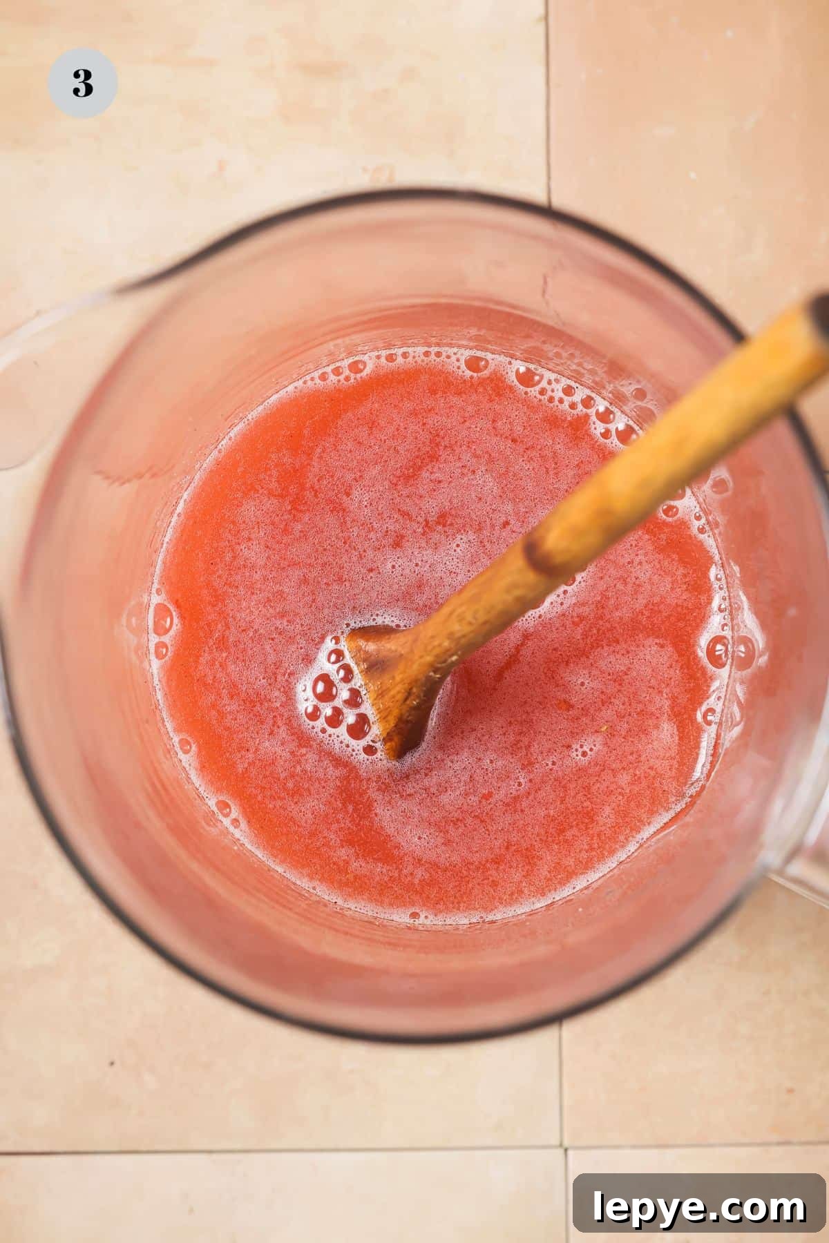 An overhead image of pour into the jar with white grape juice and stirring until combined.
