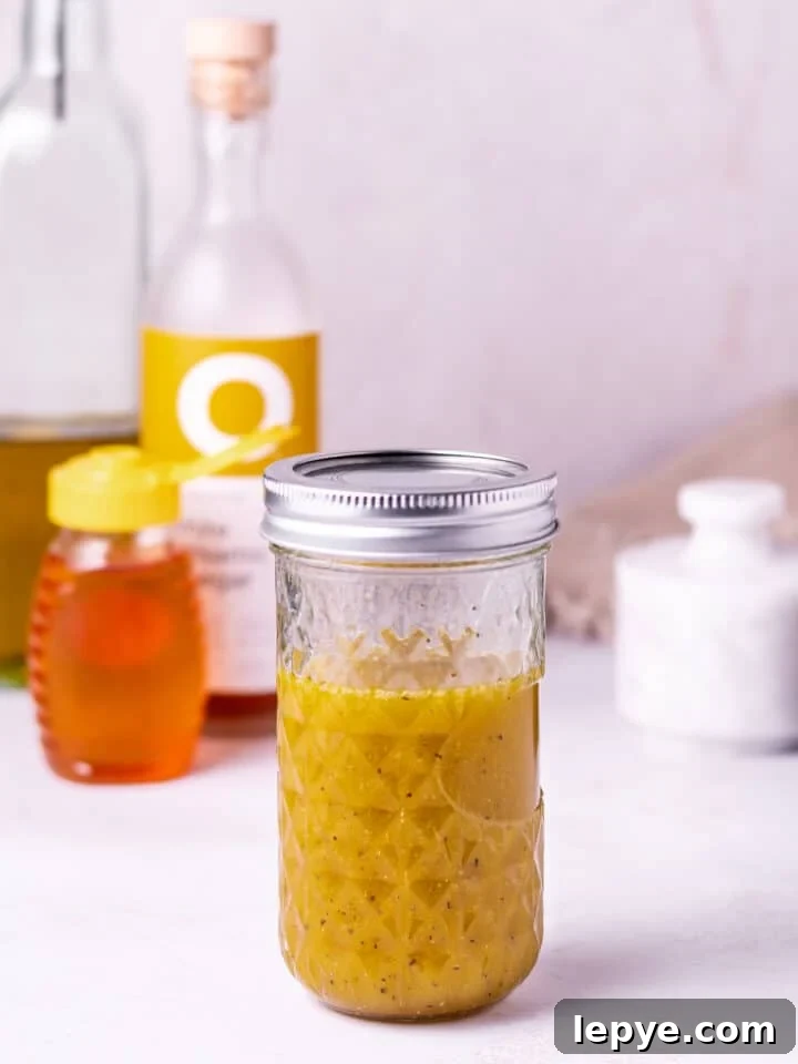 White Balsamic Vinaigrette Recipe: Tangy Salad Dressing with Herbs 2 mason jar with white balsamic vinaigrette salad dressing