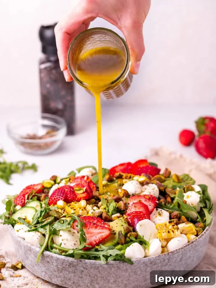 White Balsamic Vinaigrette Recipe: Tangy Salad Dressing with Herbs 11 pouring white balsamic dressing on spinach arugula salad
