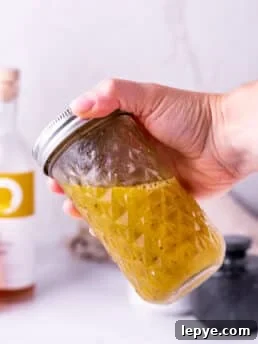 hand shaking white balsamic vinaigrette