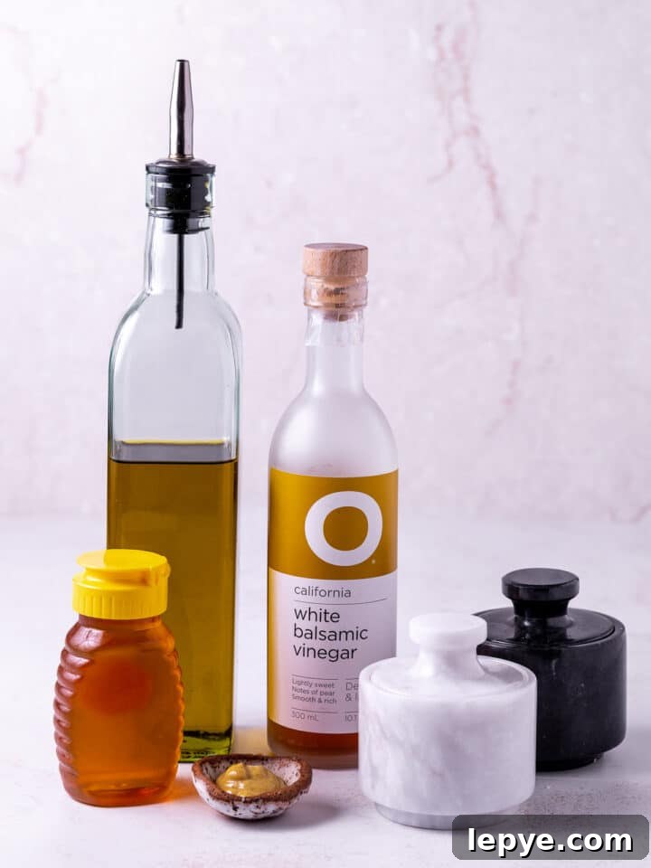 White Balsamic Vinaigrette Recipe: Tangy Salad Dressing with Herbs 3 picture of extra virgin oliveoil, white balsamic vinegar, honey, dijon mustard, salt and pepper- ingredients needed to make white balsamic vinaigrette