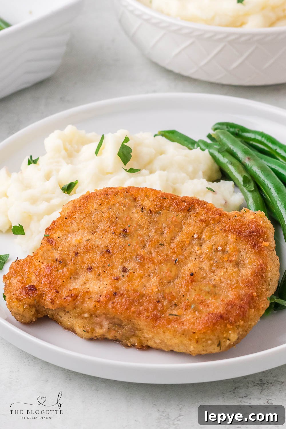 Breaded Fried Pork Chops cooked to crispy perfection! Golden brown boneless pork chops are crispy on the outside and juicy on the inside.