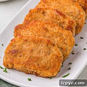 Breaded Fried Pork Chops cooked to crispy perfection! Golden brown boneless pork chops are crispy on the outside and juicy on the inside.