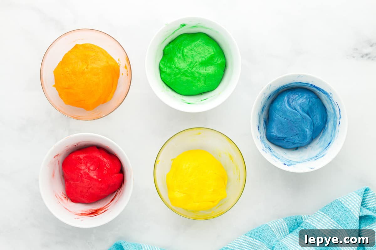 5 colored bowls of jello cookie dough.