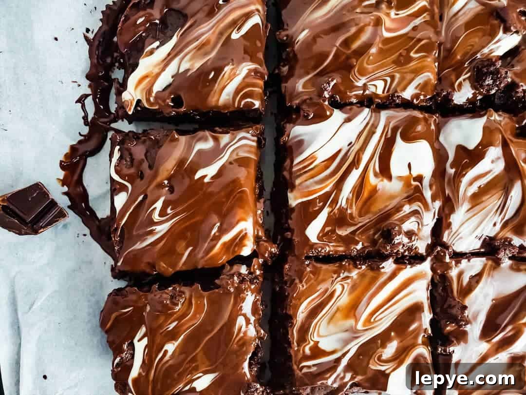 Gooey Chocolate Fudge Brownies with Rich Chocolate Drizzle 15 Overhead shot of brownies on parchment paper.