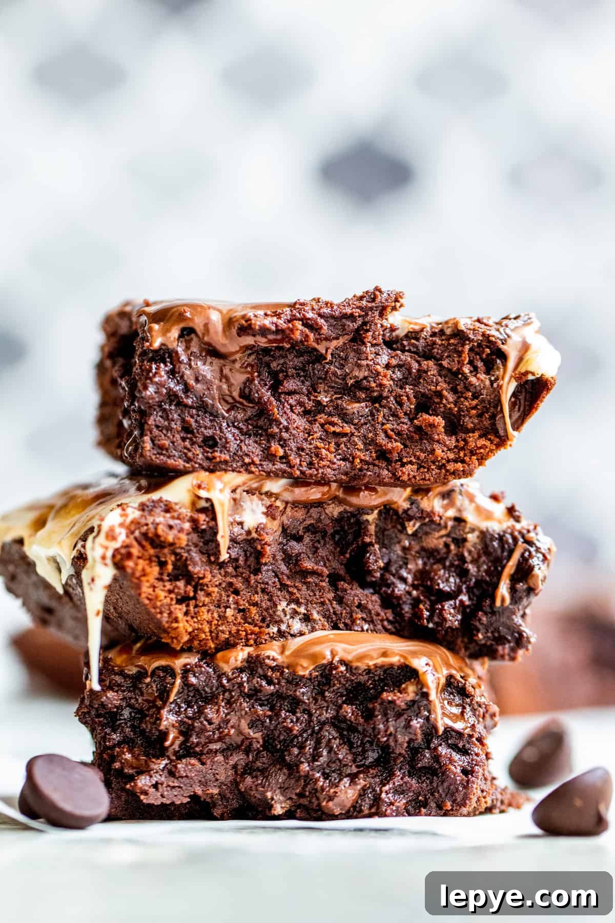 Gooey Chocolate Fudge Brownies with Rich Chocolate Drizzle 7 Straight on shot of fudge brownies in stack of three.