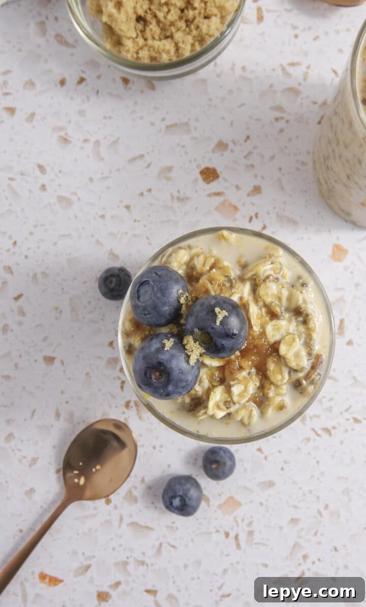 overhead shot of overnight oats in glass jars topped with blueberries