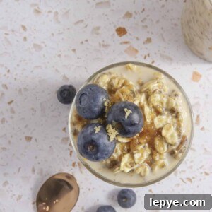 overhead shot of overnight oats in glass jars topped with blueberries