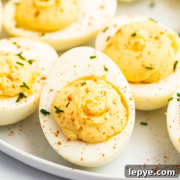 Smoked Tomato Recipe: How to Smoke Tomatoes for Rich Flavor 13 Creamy deviled eggs garnished with paprika and chives on a white plate