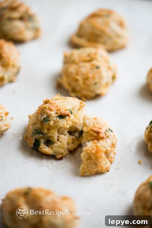Flaky Garlic Cheddar Drop Biscuits perfect for biscuits and gravy | @bestreciepbox Flaky Garlic Cheddar Drop Biscuits on a cutting board