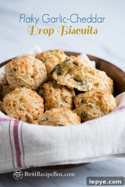 Flaky Garlic Cheddar Drop Biscuits perfect for biscuits and gravy | @bestreciepbox Flaky Garlic Cheddar Drop Biscuits in a wooden bowl