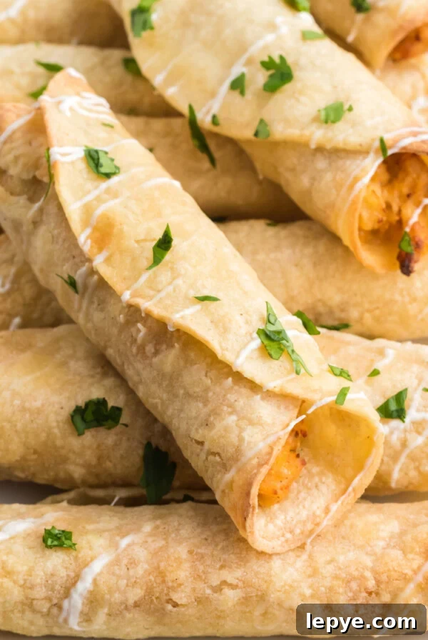 Crispy Bacon-Wrapped Chicken Bites Made in the Air Fryer 9 Chicken taquitos made in the air fryer and topped with sour cream and cilantro before serving.